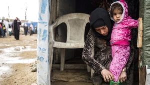 3-year-old Syrian girl Salwa* puts her shoes on with the help of her mother before the leaves her tent to go outside and play with her friends. Additional Information In response for the winter storms that are hitting Lebanon Save the Children staff members in Bekaa valley, in the the eastern side of Lebanon visited refugees and offered them weatherproofing kits. Plastic sheets and wooden timbers were also distributed to help refugees support their tents.