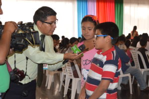 Lucas speaking to local media at the anniversary celebration for the Convention on the Rights of the Child.
