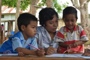 Author Yasintha working with kids who benefit from sponsorship programs like Reading Camps.
