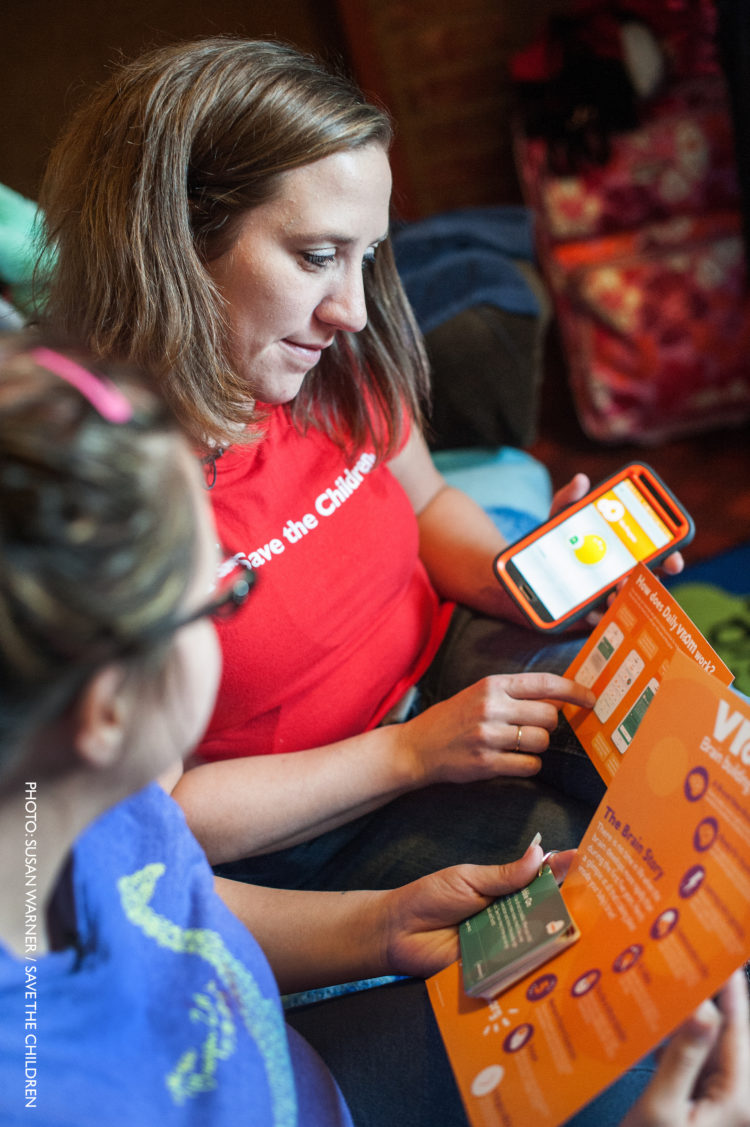 Early Steps to School Success home visitor demonstrates Vroom resources.