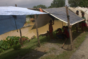 Children in Saptari taking refuge in temporary shelters while their homes are submerged in flood waters.
