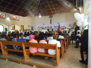 Families gathering for mass at the Saint Claire Catholic church.