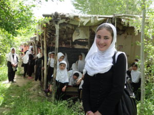 Massouma outside the old school building, before sponsors supported new classrooms.