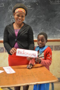 Modester in her classroom in Zomba, with one of her students.