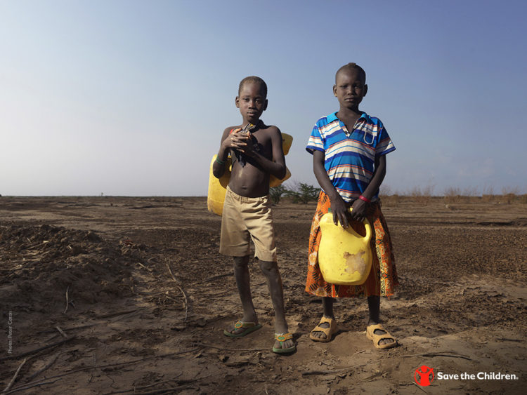 James, age 6, and Heshima, age 8, carry water from a dried up riverbed in Turkana County, Kenya. Photo credit: Peter Caton \ Save the Children, July 2018