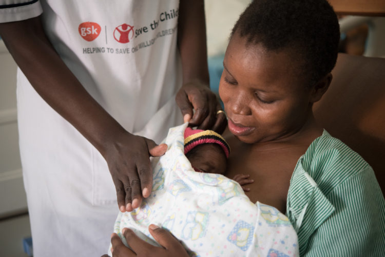 A mother cradles her newborn baby at a hospital in Kenya.